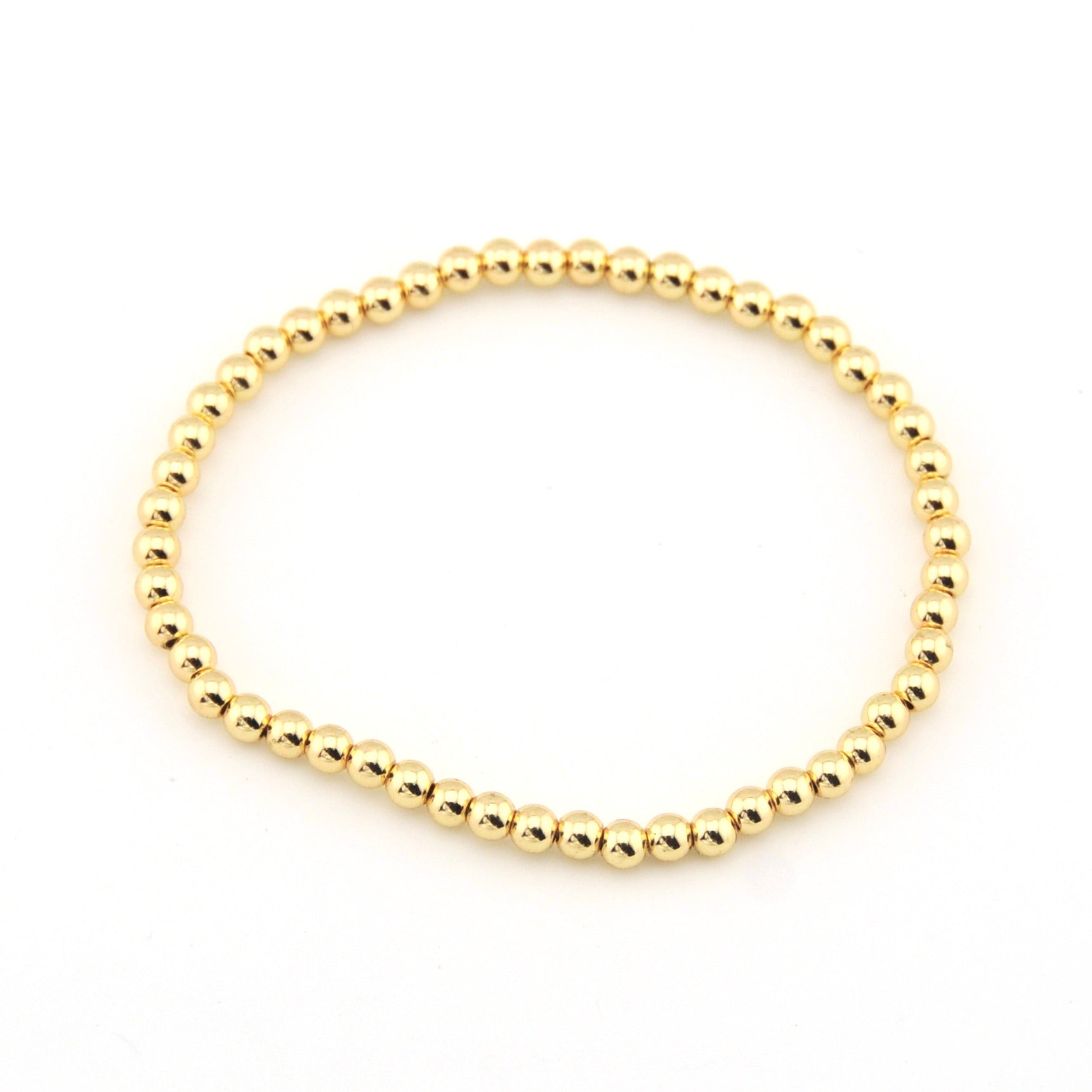 Gold beaded bracelet on a white background