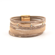 Stack of metallic bracelets on a white background