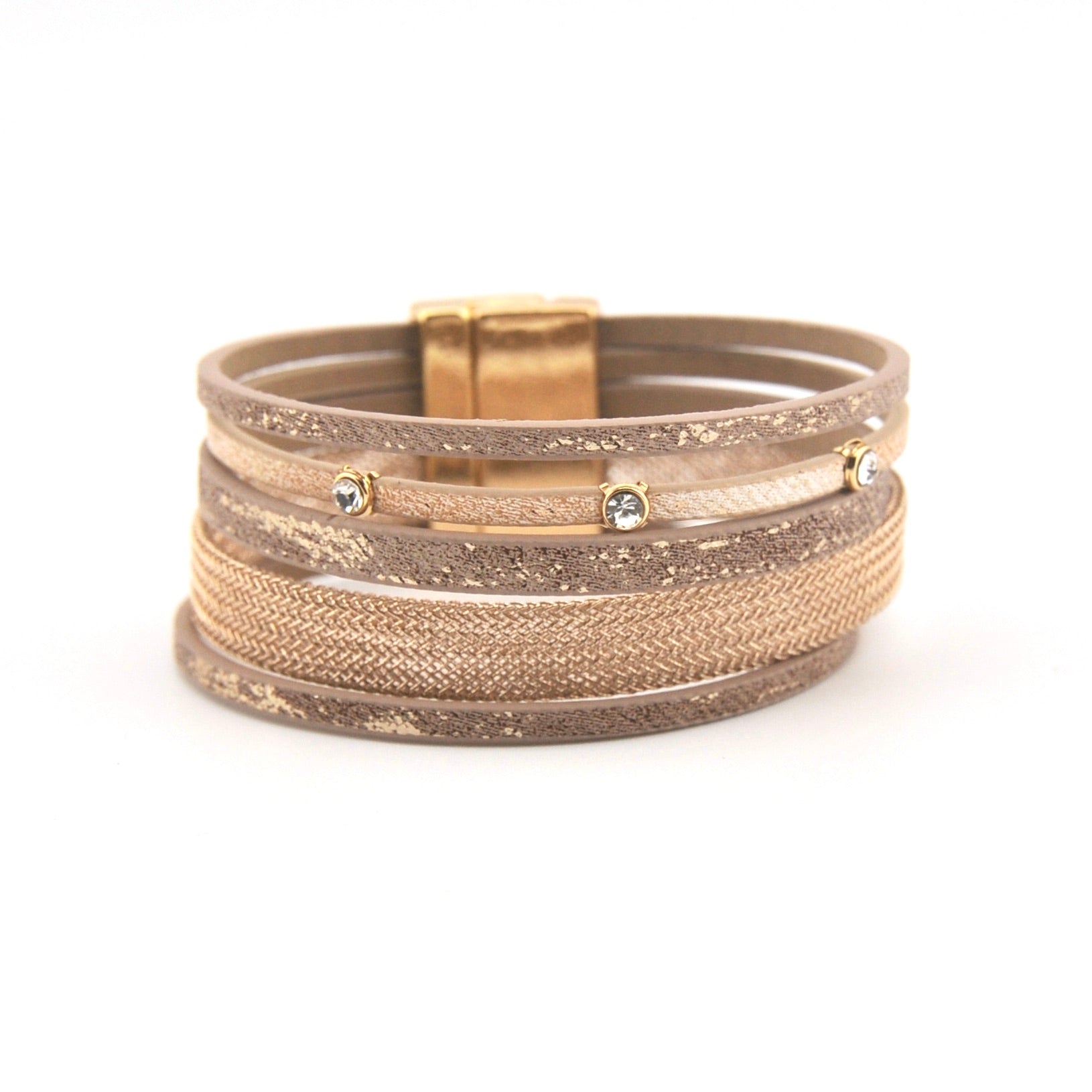 Stack of metallic bracelets on a white background