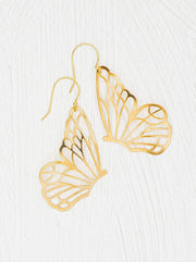 Gold butterfly-shaped earrings on a white background