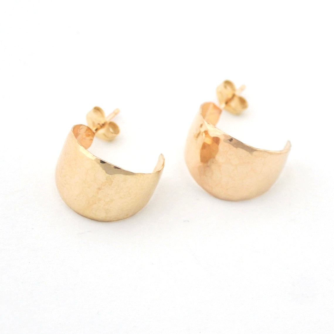 Pair of gold hoop earrings on a white background