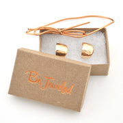 Gold hoops in a 'Be Jeweled' box on a white background