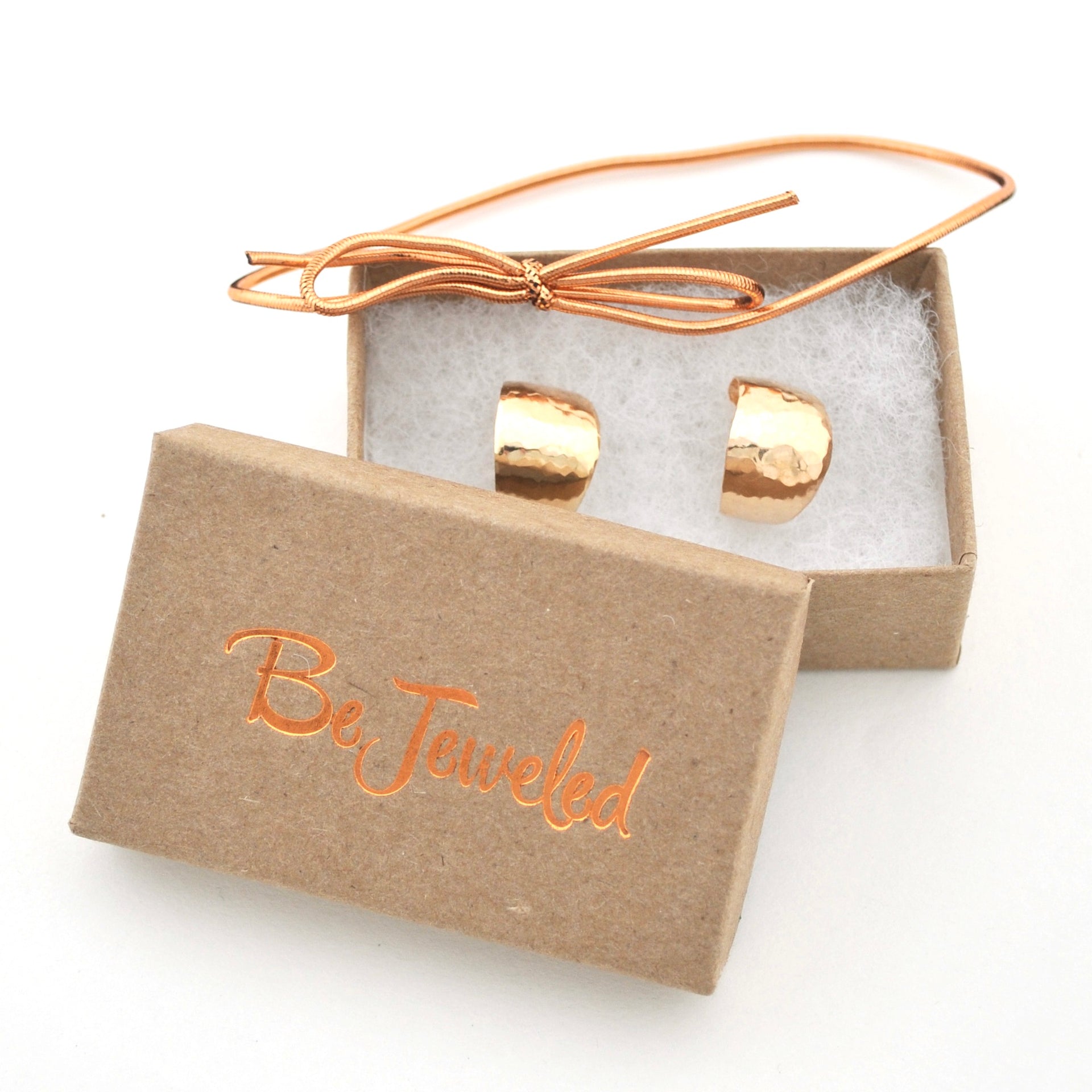 Gold hoops in a 'Be Jeweled' box on a white background