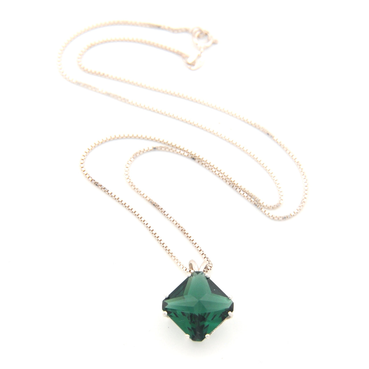 Necklace with a green pendant on a white background