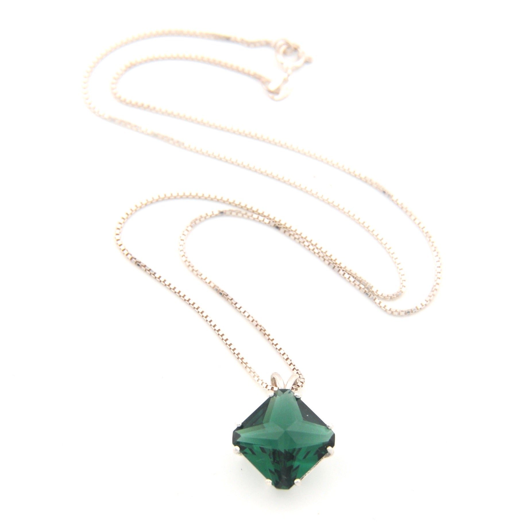 Necklace with a green pendant on a white background