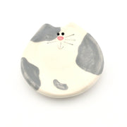 Cat-shaped ceramic dish with a white background
