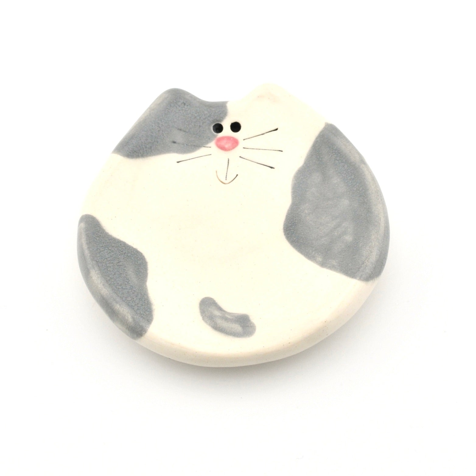 Cat-shaped ceramic dish with a white background