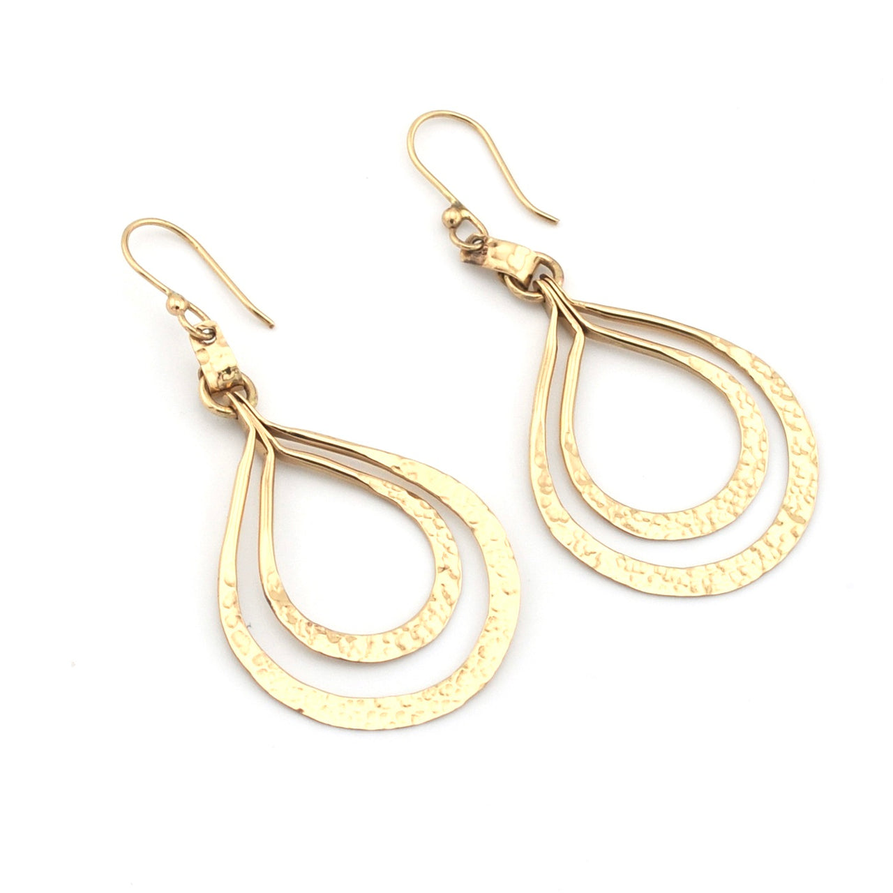 Gold teardrop earrings on a white background