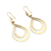 Gold teardrop earrings on a white background
