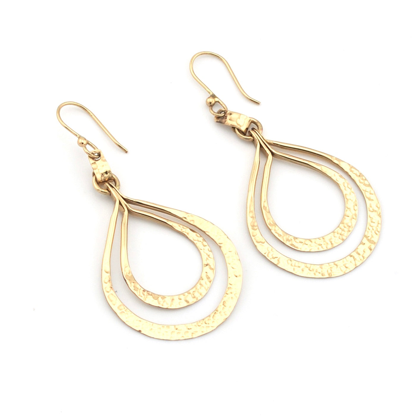 Gold teardrop earrings on a white background
