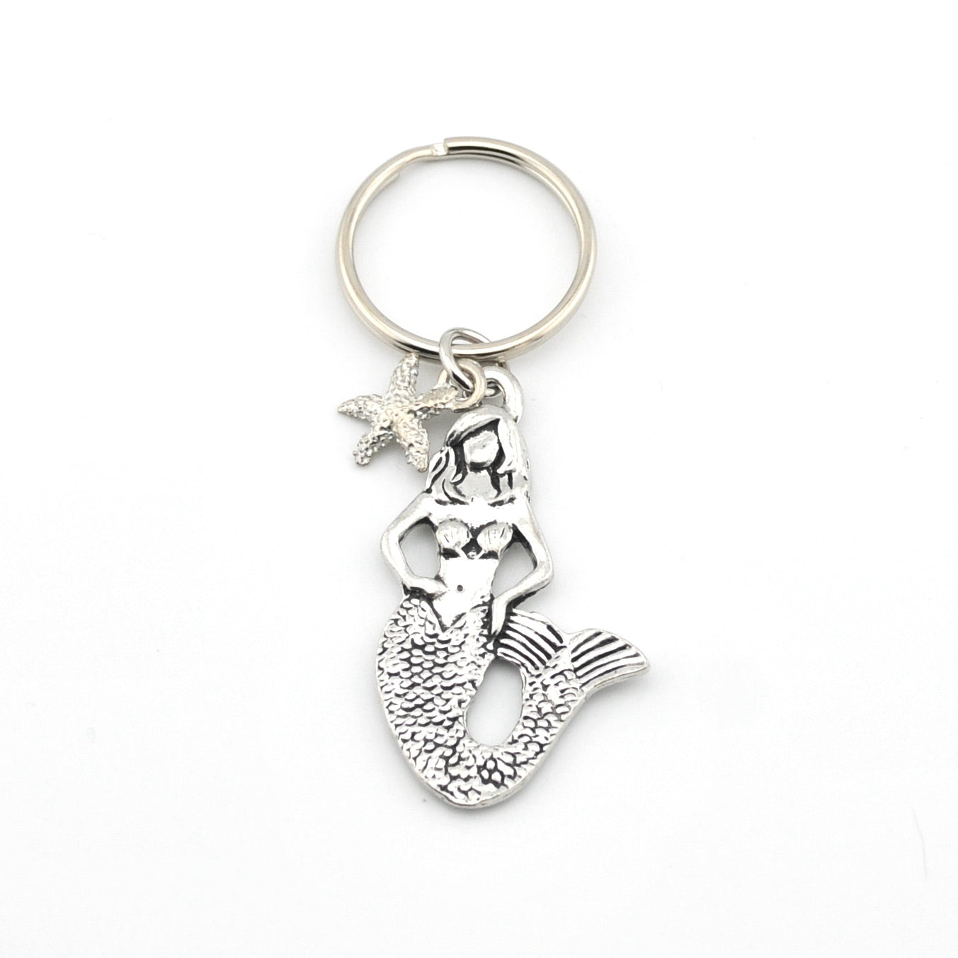 Silver mermaid keychain with starfish charm on a white background