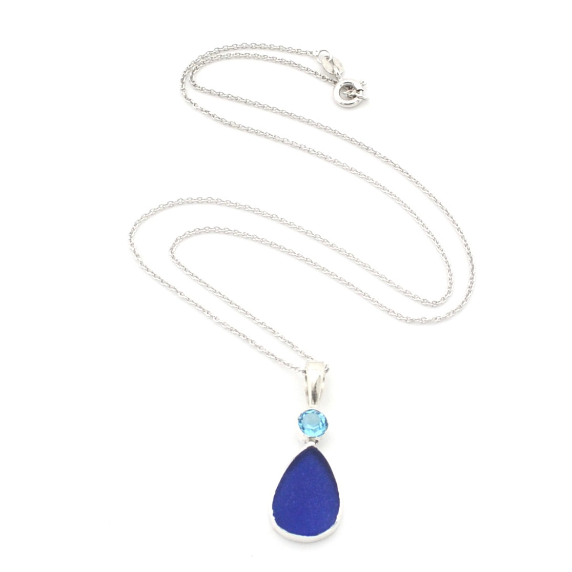 A silver chain necklace featuring a teardrop-shaped dark blue stone pendant and a small round light blue stone above it, displayed on a clean white background.