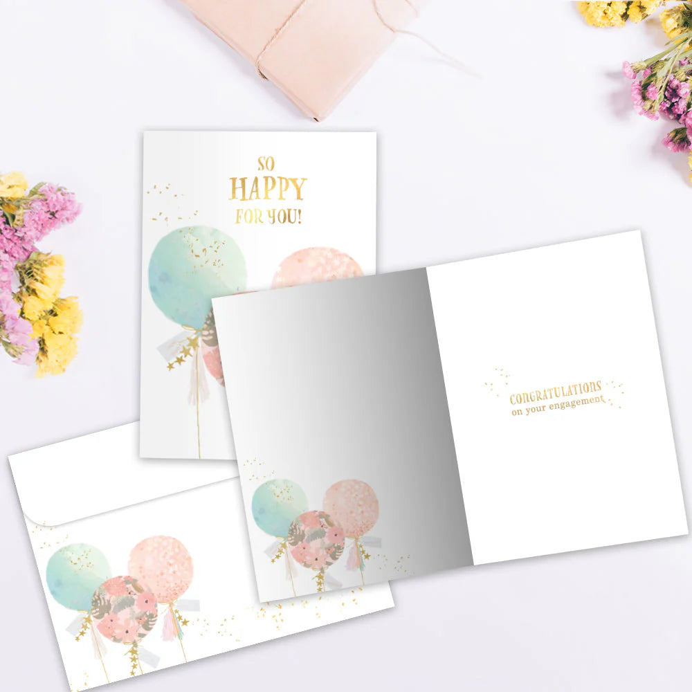 Set of greeting cards with balloons and floral designs on a white surface.