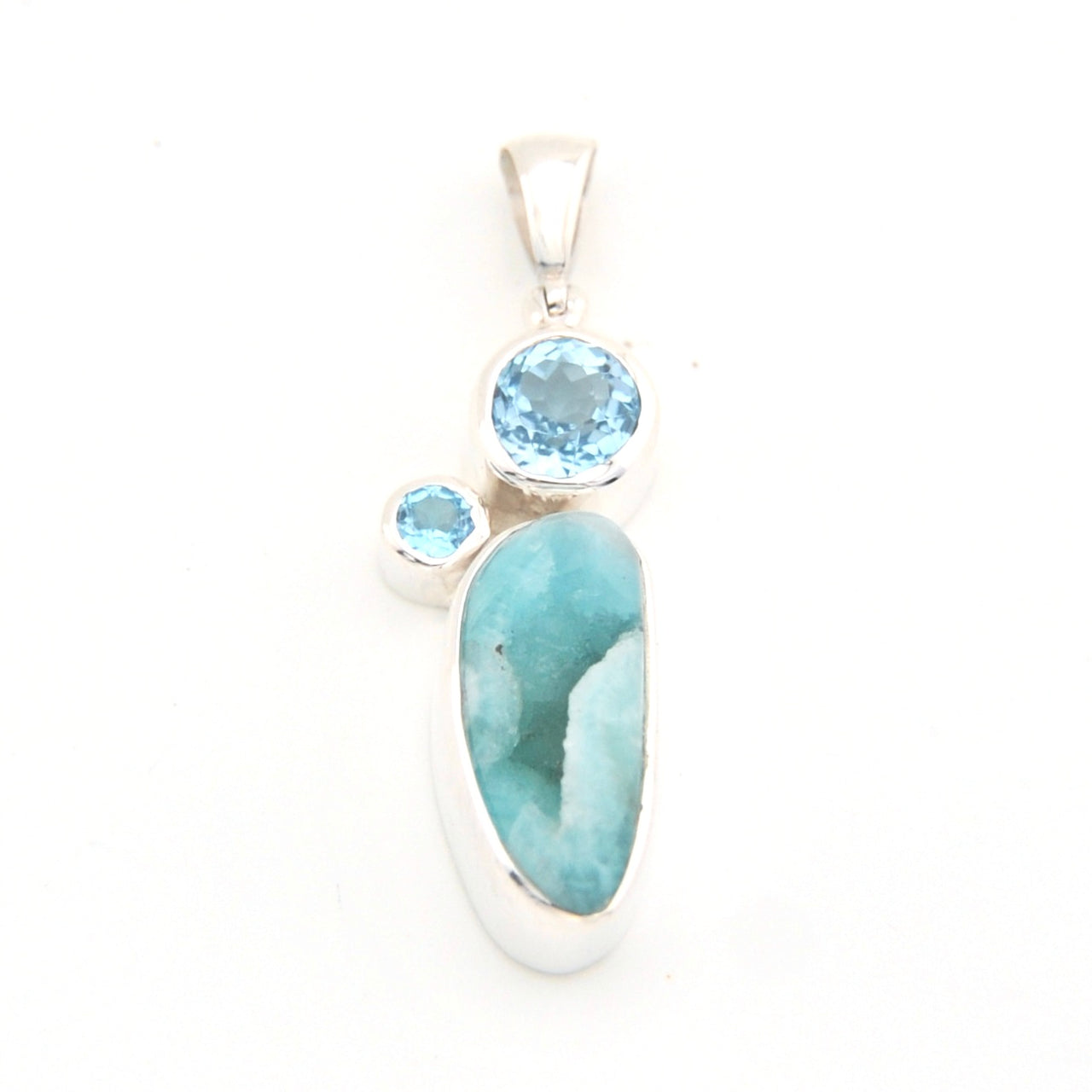 Jewelry pendant with blue stones on a white background