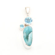 Jewelry pendant with blue stones on a white background