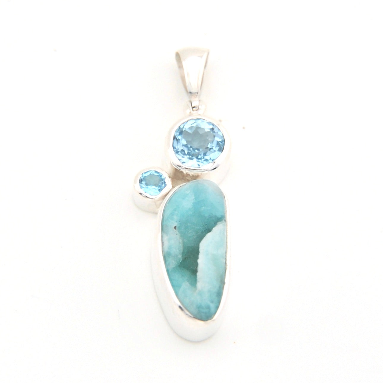Jewelry pendant with blue stones on a white background