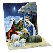 A 3D pop-up Christmas nativity scene card with a detailed illustration of Mary, Joseph, baby Jesus, the three wise men, and animals under a starry night sky. The card is shown partially unfolded on a white background.