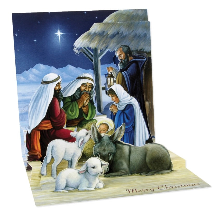 A 3D pop-up Christmas nativity scene card with a detailed illustration of Mary, Joseph, baby Jesus, the three wise men, and animals under a starry night sky. The card is shown partially unfolded on a white background.