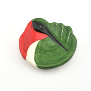 Decorative object with red, green, and white colors on a white background