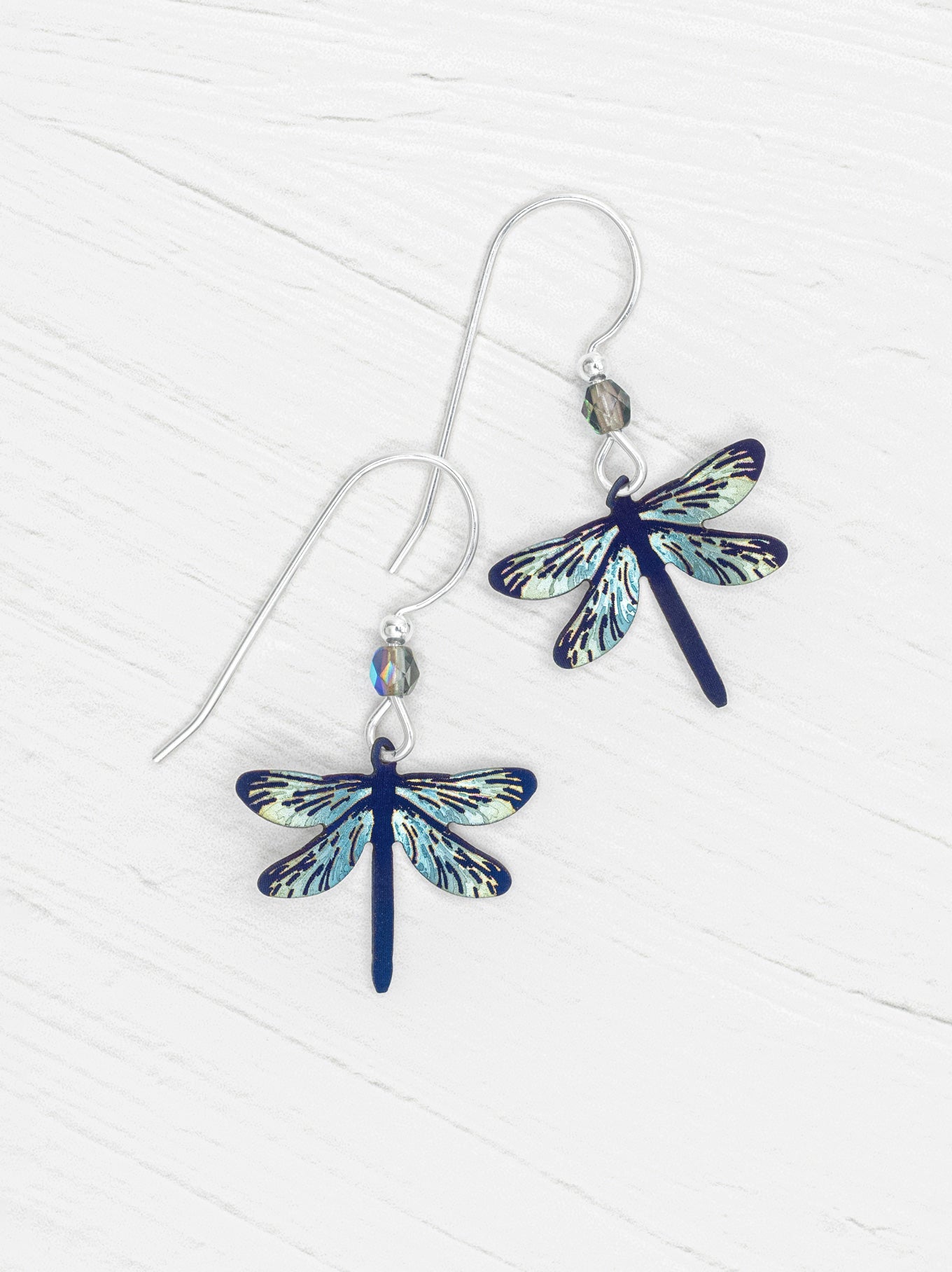 Dragonfly-shaped earrings on a white background