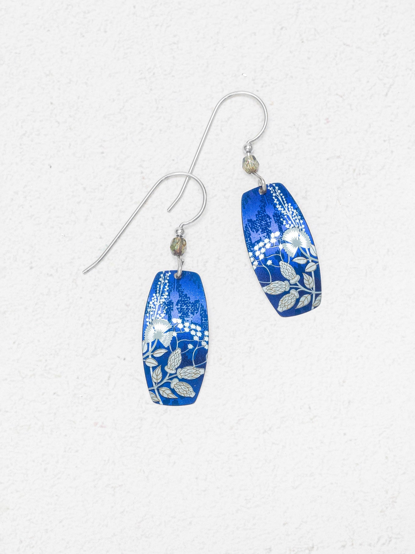 Pair of blue patterned earrings on a white background