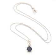 Silver necklace with a deep blue violet teardrop pendant on a white background