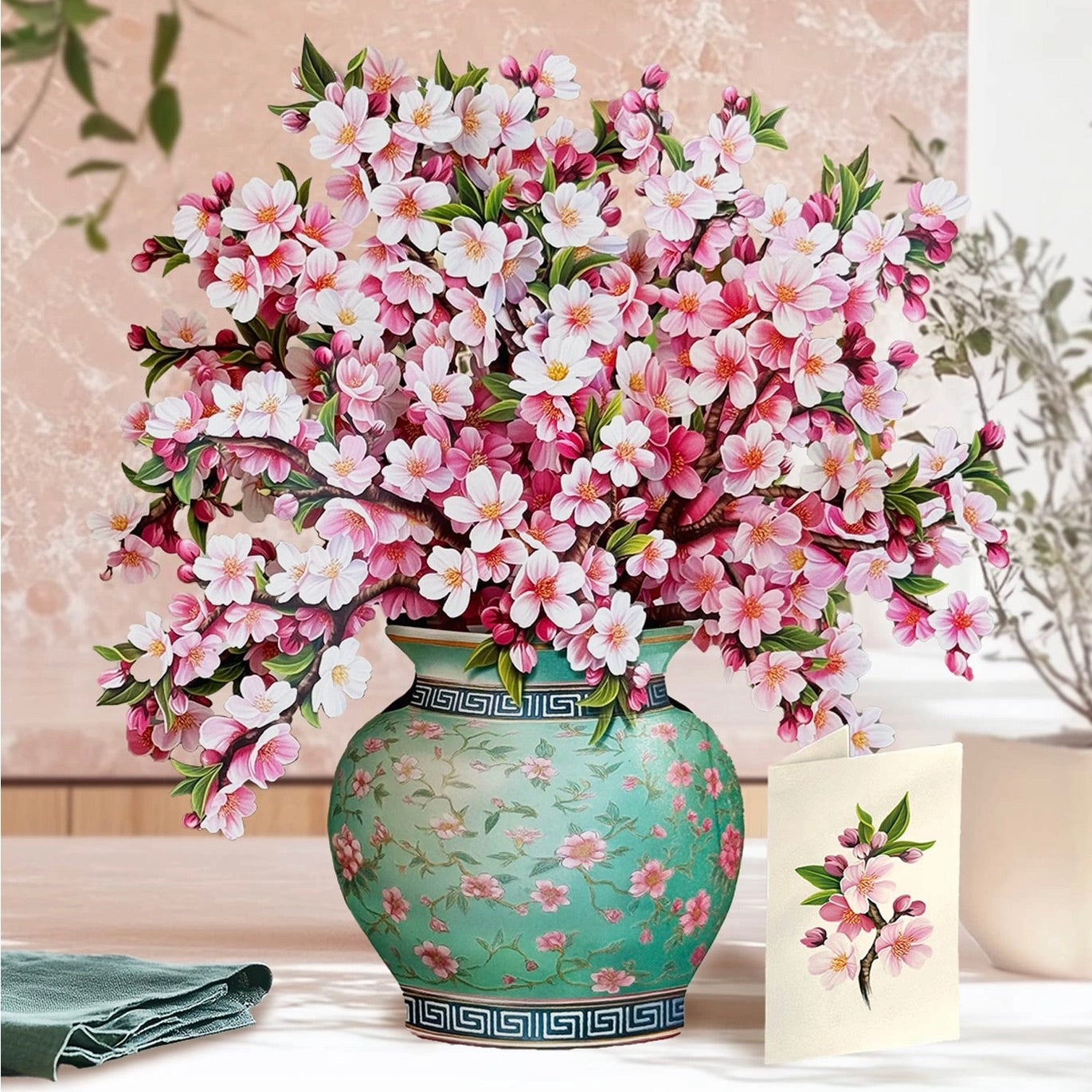 Bouquet of pink and white flowers in a decorative vase on a table.