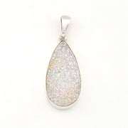 Teardrop-shaped pendant with silver frame on a white background