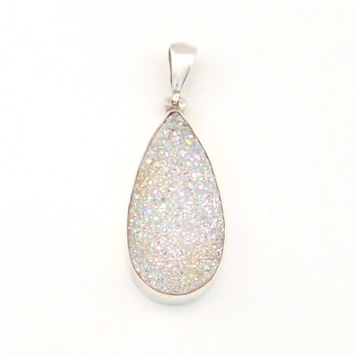 Teardrop-shaped pendant with silver frame on a white background