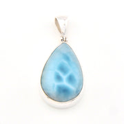 Teardrop-shaped blue pendant on a white background