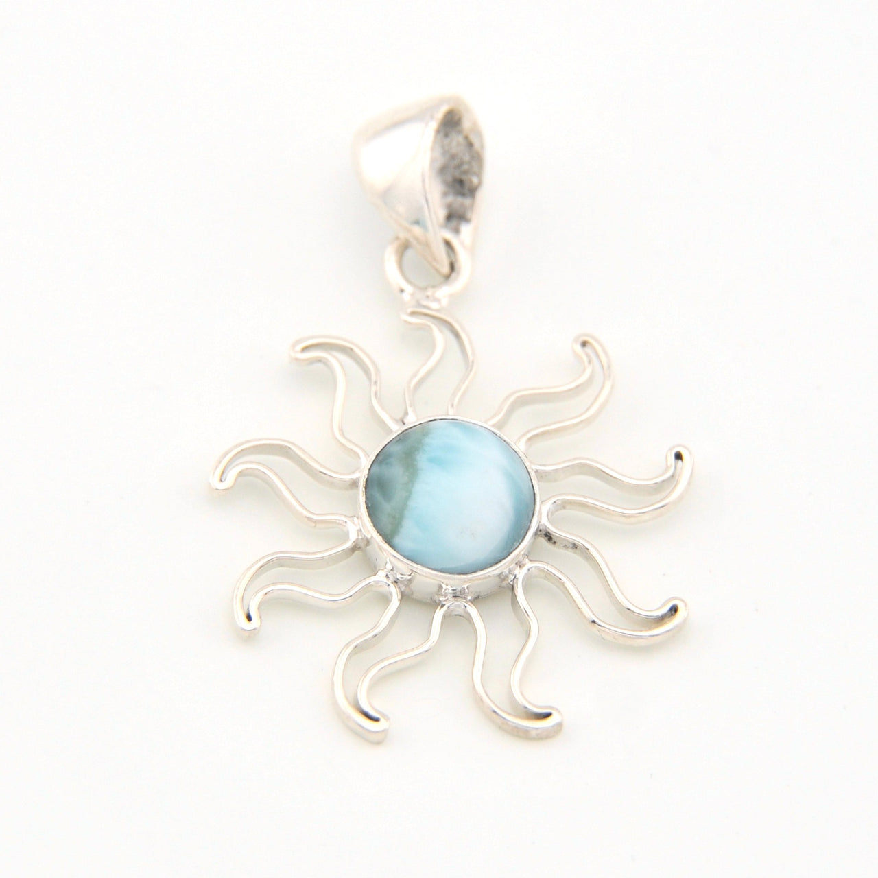 Silver sun-shaped pendant with a blue center on a white background