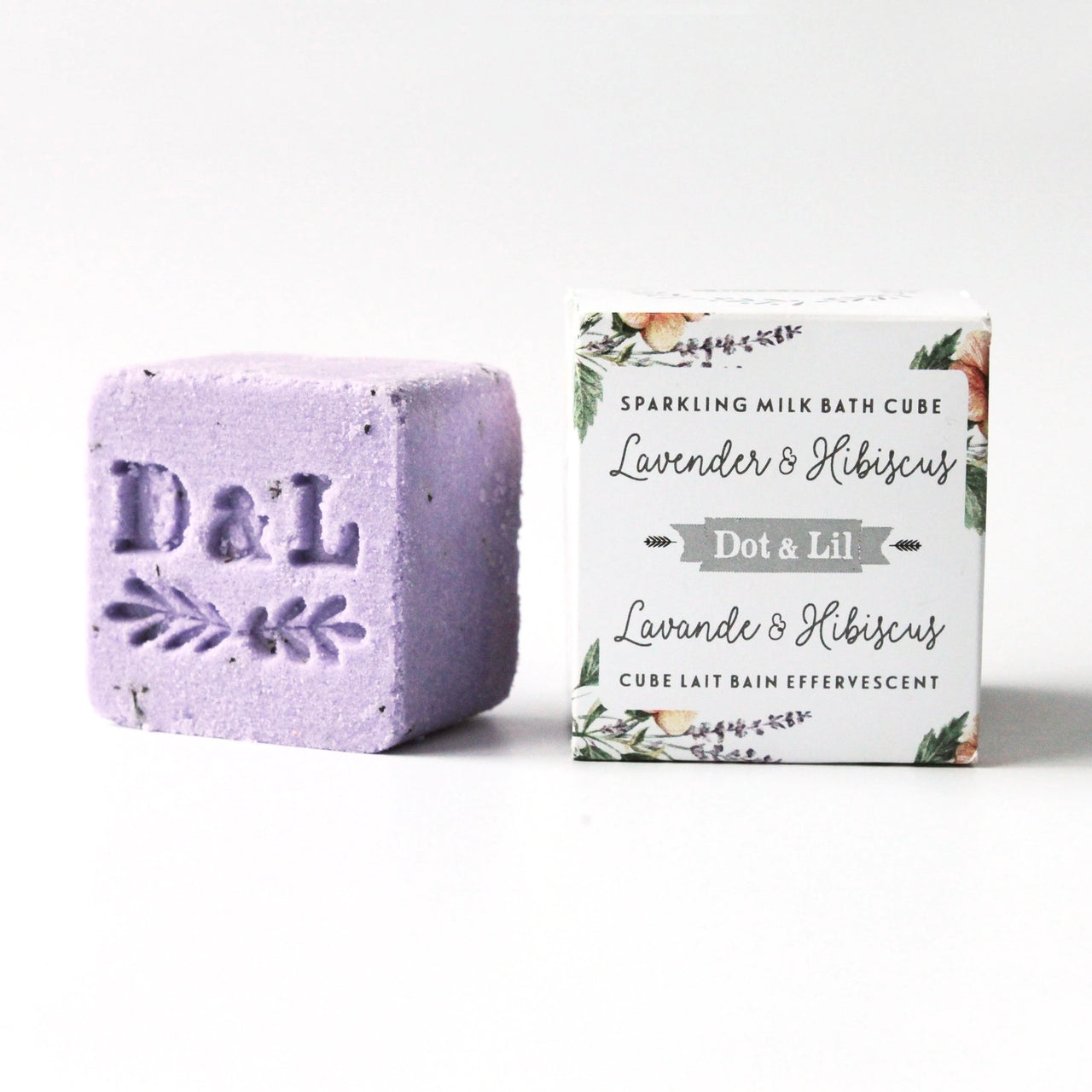 Purple bath cube with 'D&L' branding next to its packaging on a white background