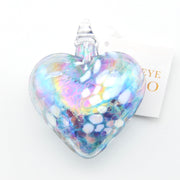 Heart-shaped glass ornament with iridescent finish on a white background