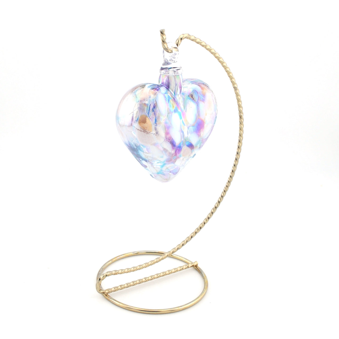 Heart-shaped glass ornament with gold stand on a white background