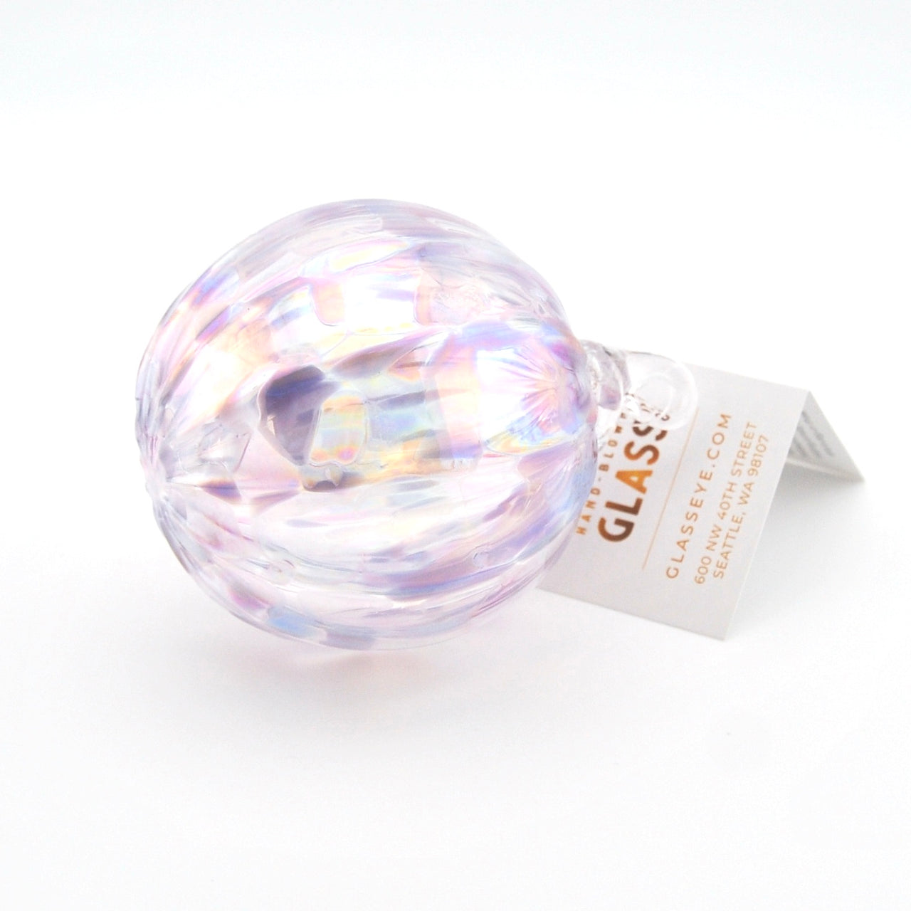 Iridescent glass ornament with a label on a white background