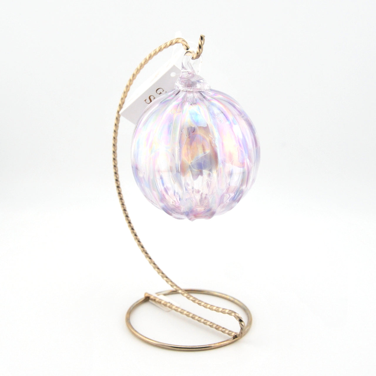 Iridescent glass ornament with a gold stand on a white background