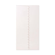 White scalloped edge napkin on a white background