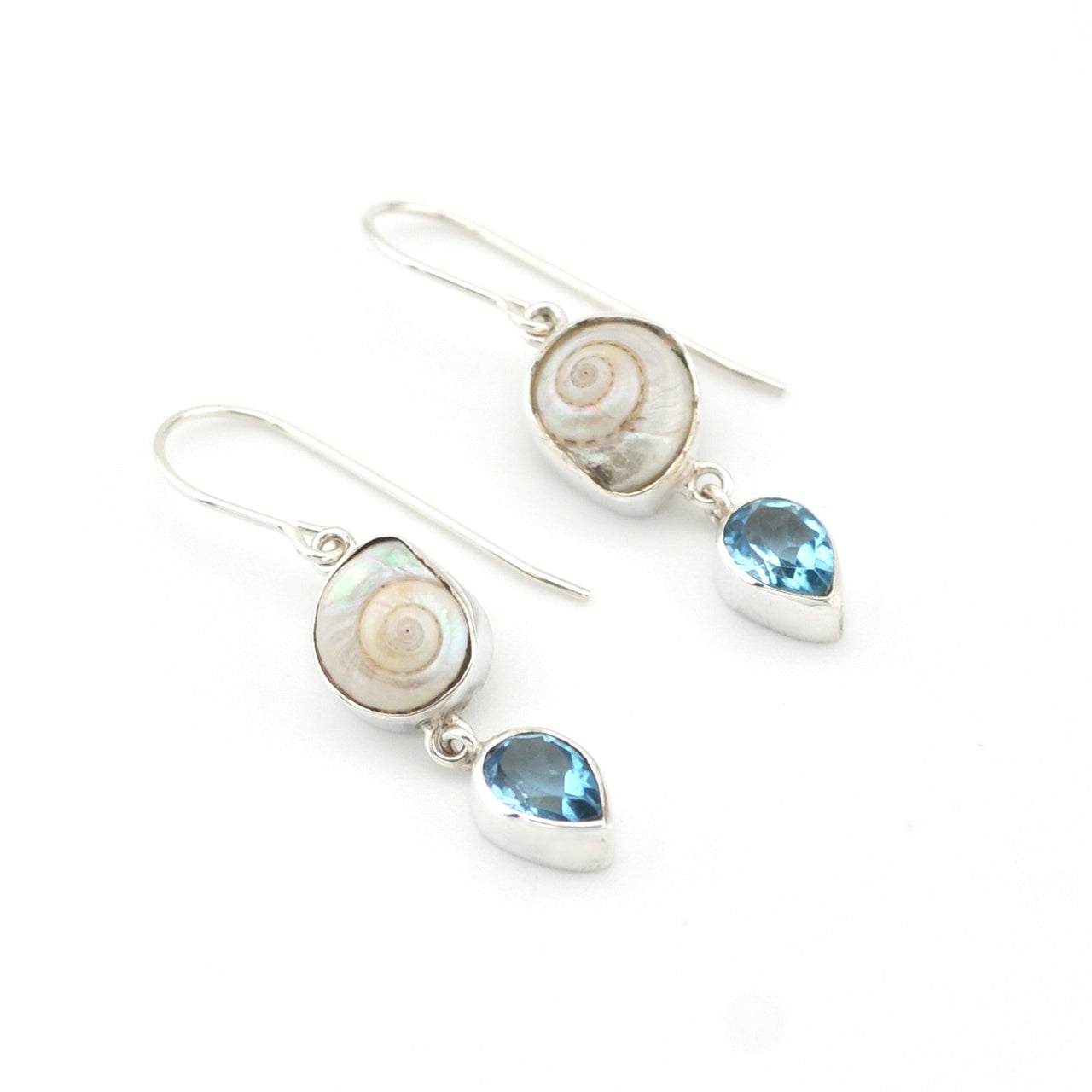 Pair of silver earrings with shell and blue gemstone drops on a white background