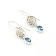 Pair of silver earrings with shell and blue gemstone drops on a white background