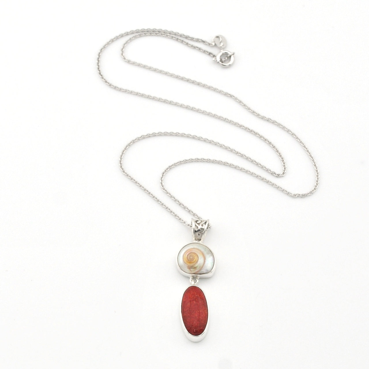 Necklace with a red pendant and silver chain on a white background