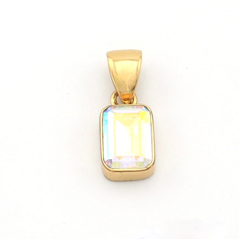 Gold pendant with a rectangular gemstone on a white background