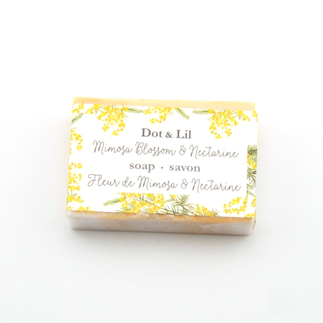 Dot & Lil Mimosa Blossom & Nectarine soap bar with floral design on a white background