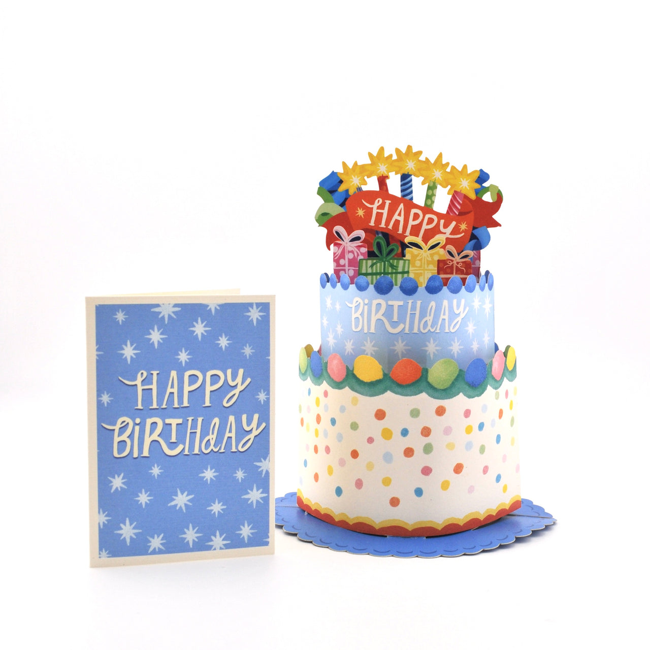 Colorful birthday cake with polka dots and a matching 'Happy Birthday' card on a white background