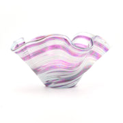 Glass bowl with purple and white swirl pattern on a white background
