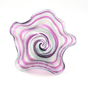 Decorative glass piece with wavy, multicolored pattern on a white background