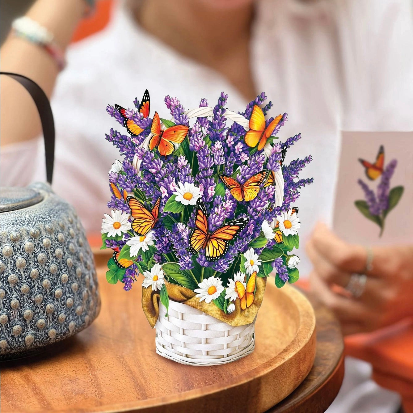 3D floral arrangement with butterflies on a wooden table