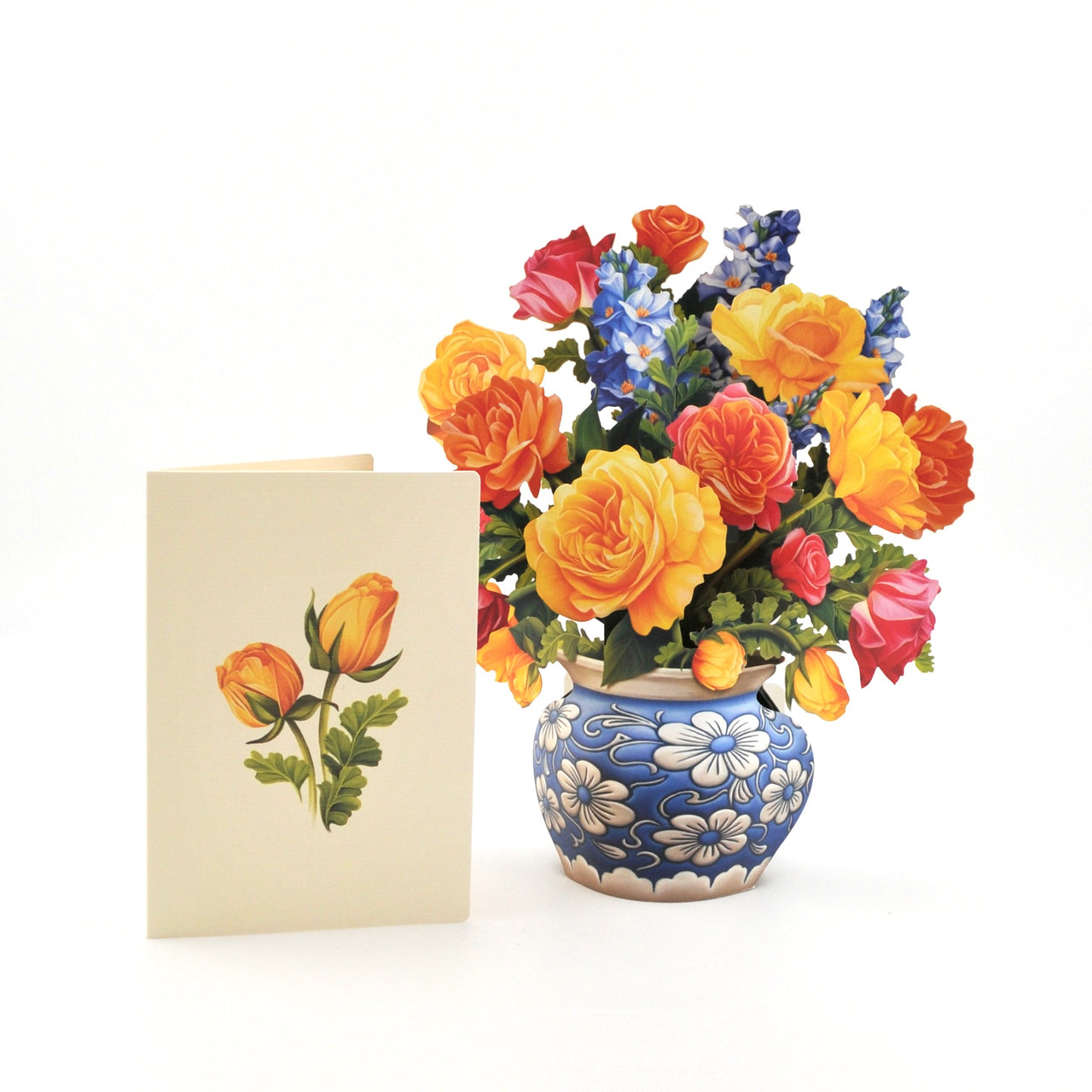 Colorful bouquet of flowers in a decorative vase next to a matching greeting card on a white background