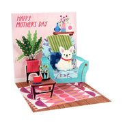Mother's Day card with a dog on a chair, plants, and a pink background.
