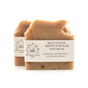 Two soap bars with labels on a white background