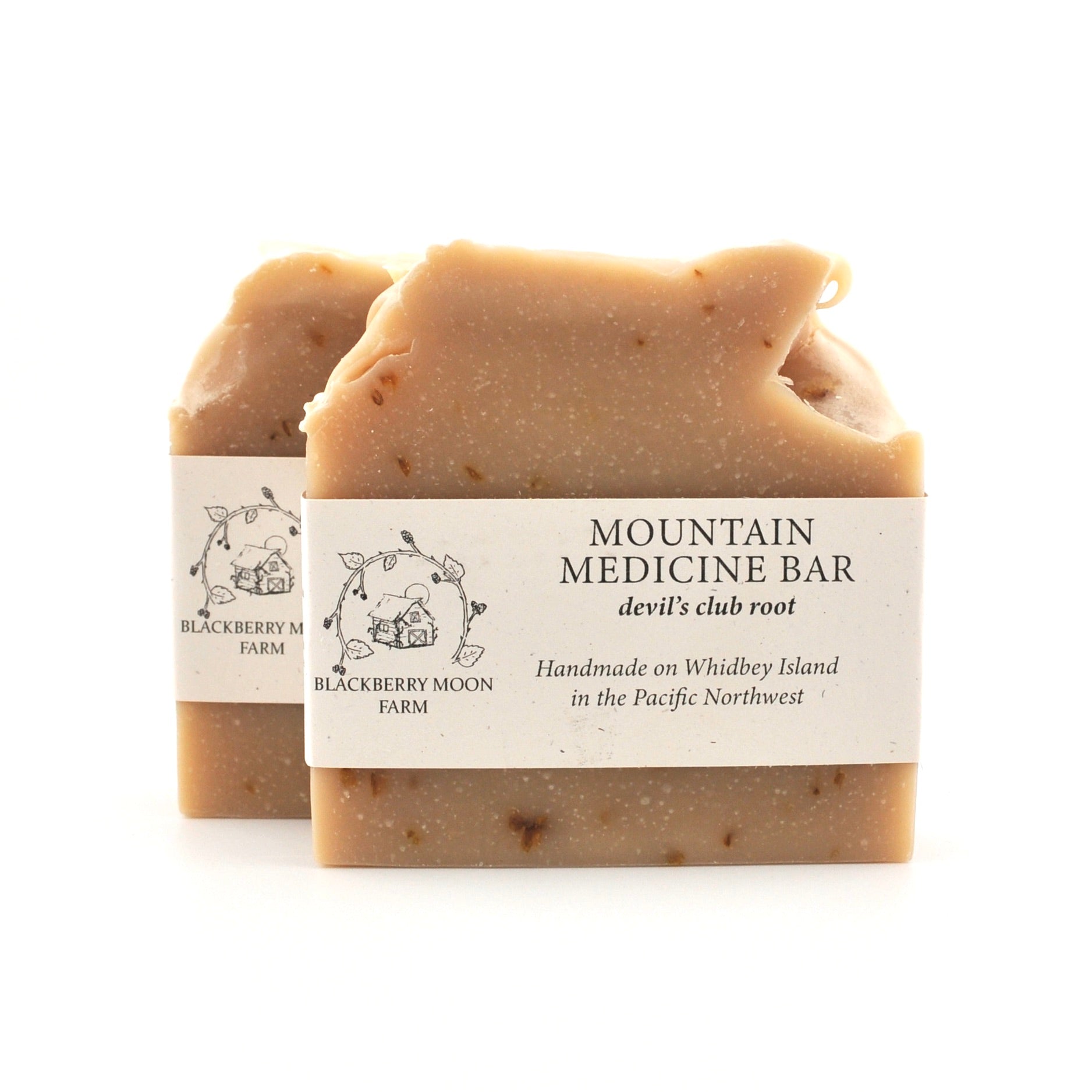 Two soap bars with labels on a white background